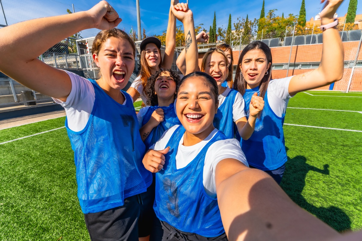 Student athletes celebrating together on a soccer field