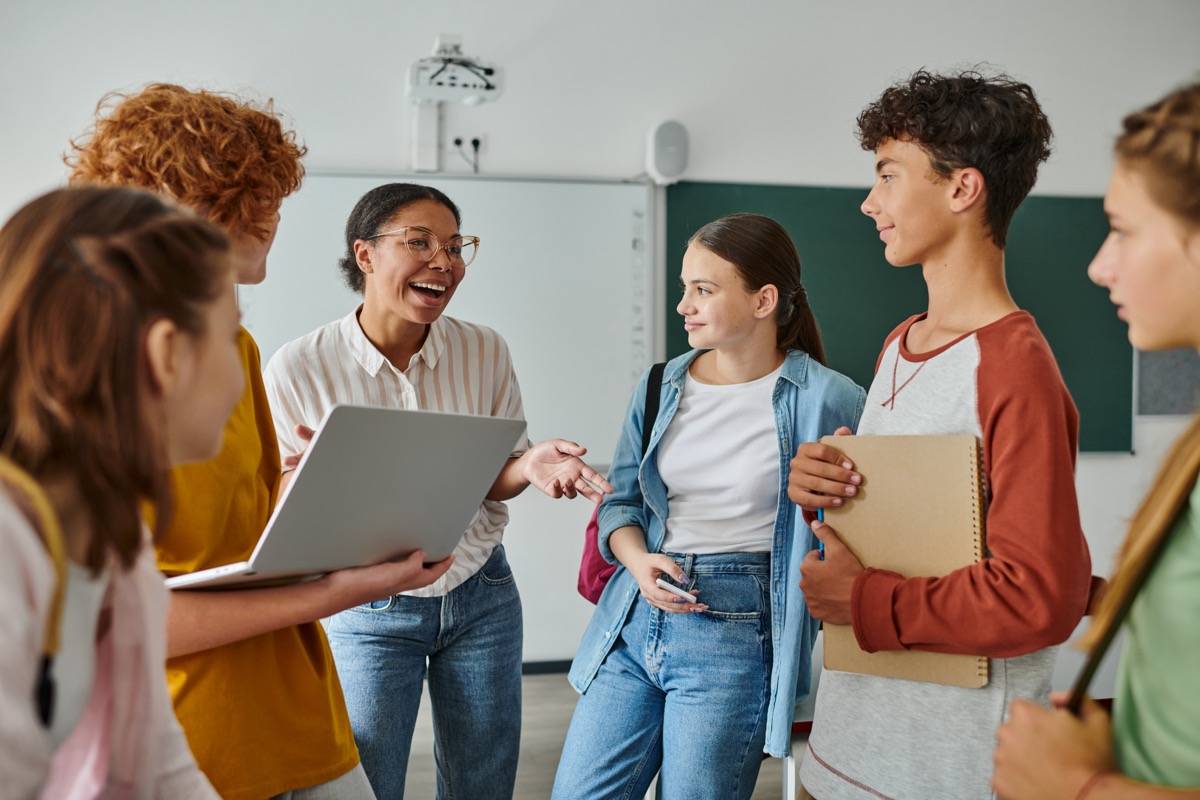 Students and a teacher collaborating in a classroom